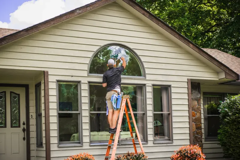 Residential exterior window cleaning with professional squeegee