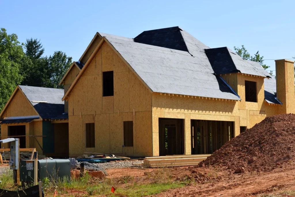 New construction home with roof underlayment and shingles going on