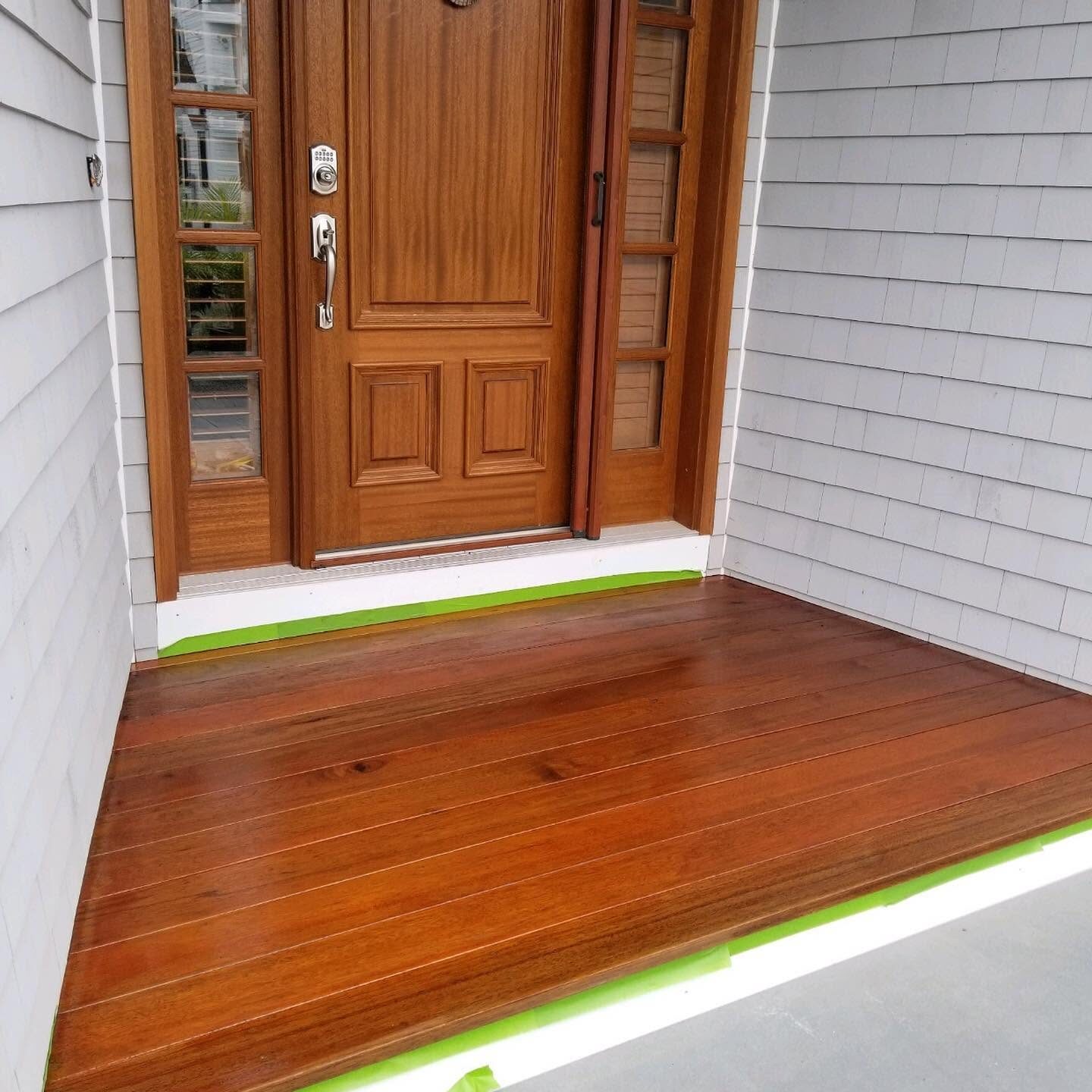 Varnished mahogany entry door and matching deck finish