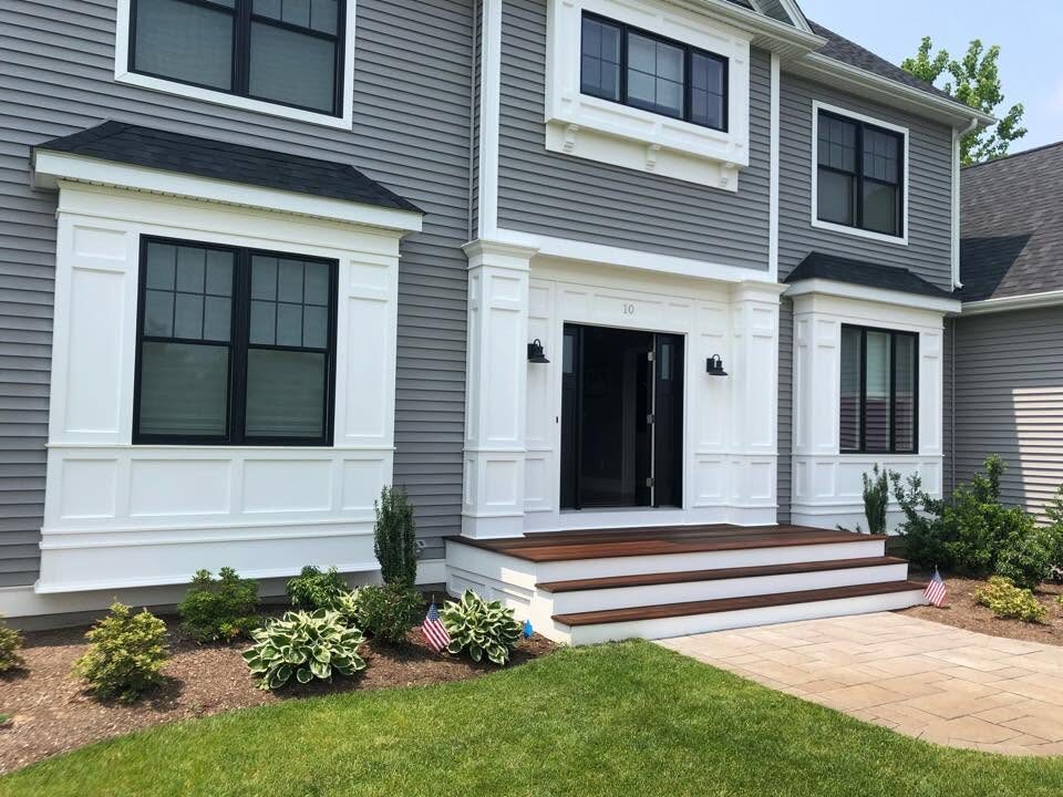 New construction exterior with painted white trim and columns