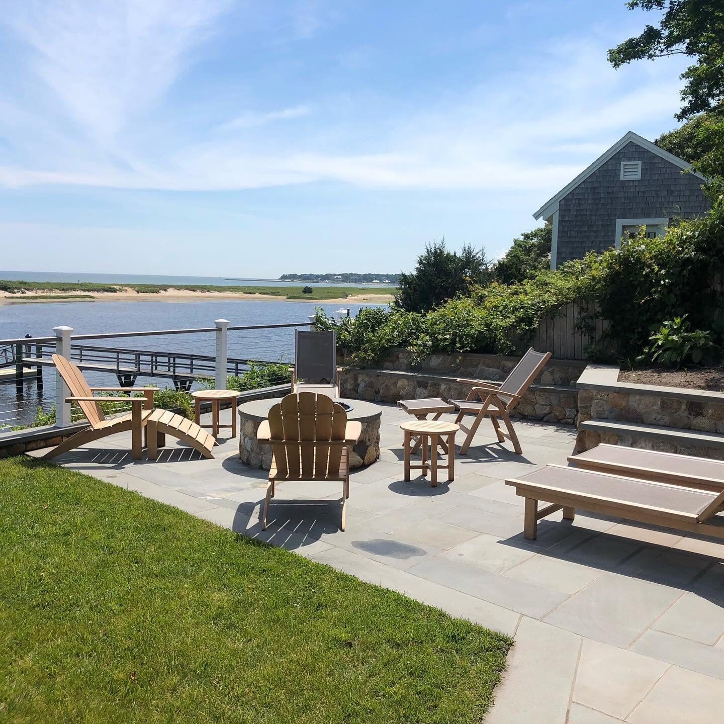 Waterfront patio and lawn at a coastal Rhode Island property