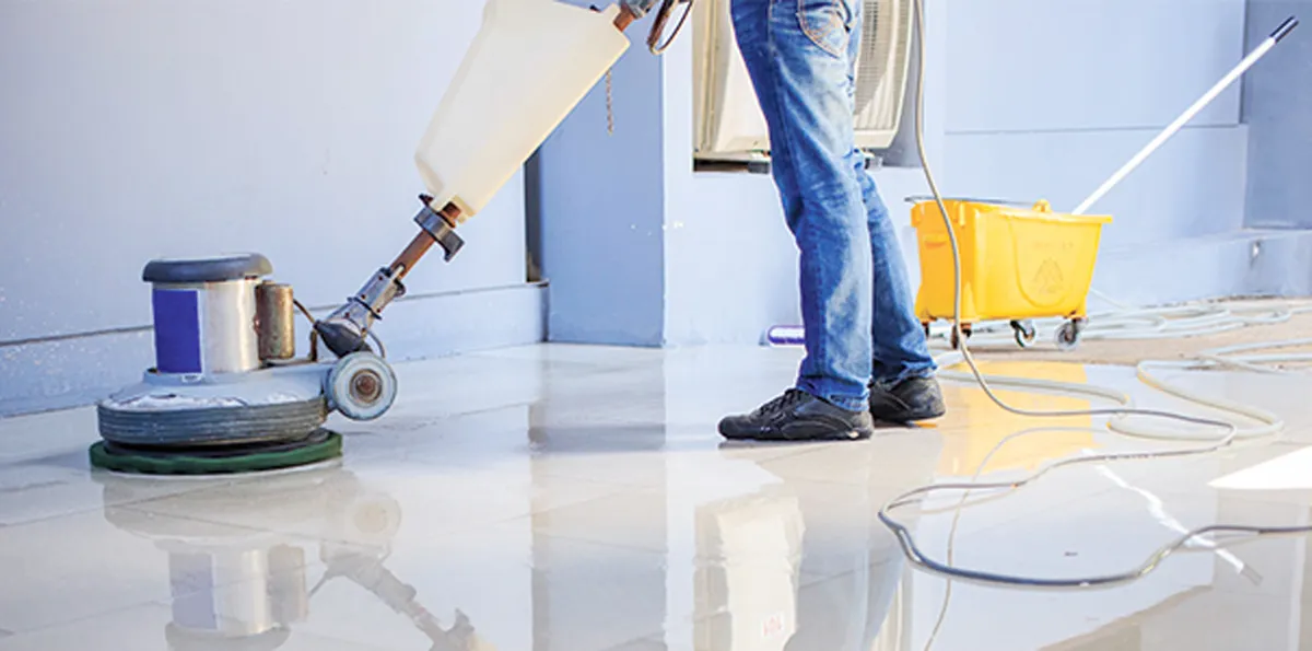 Floor machine power washing and polishing a tile floor