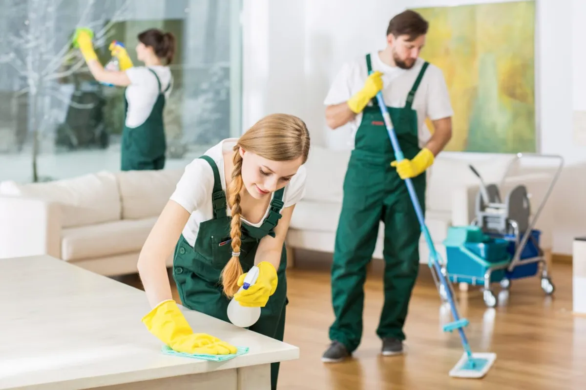 Cleaning crew deep cleaning a living room