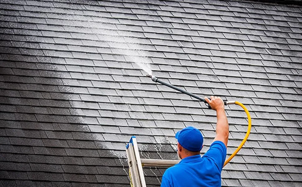 Roof soft washing removing algae streaks from asphalt shingles