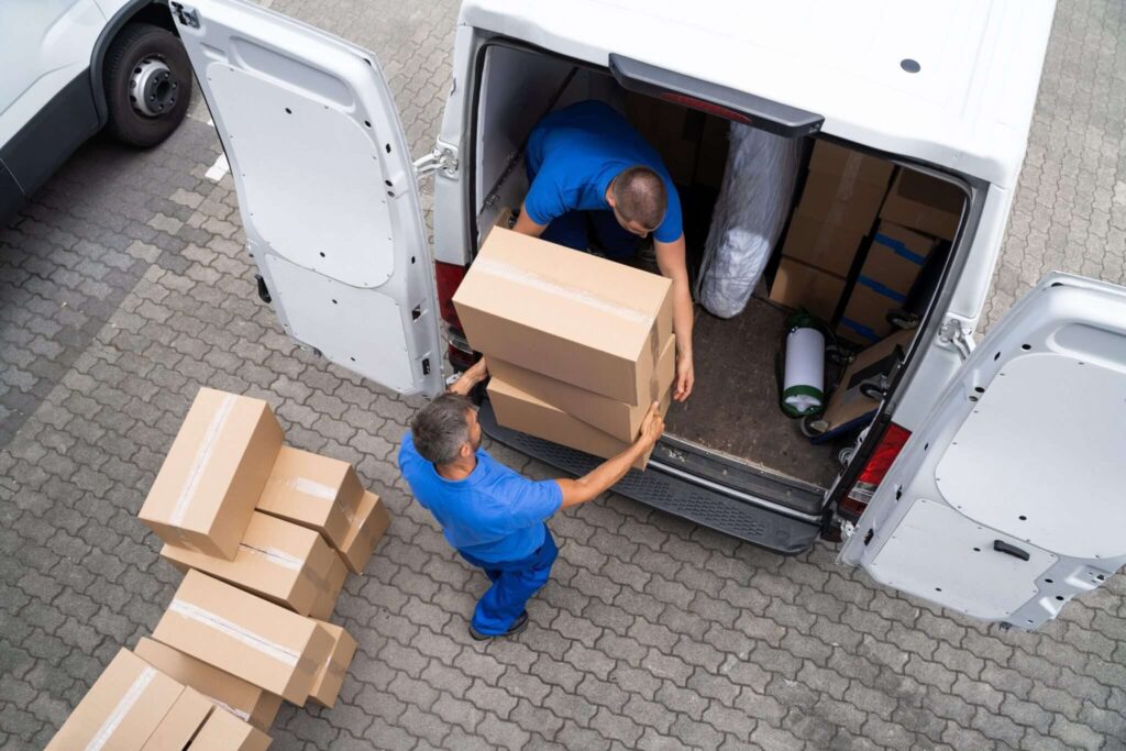 Overhead view of movers unloading boxes from the back of a van