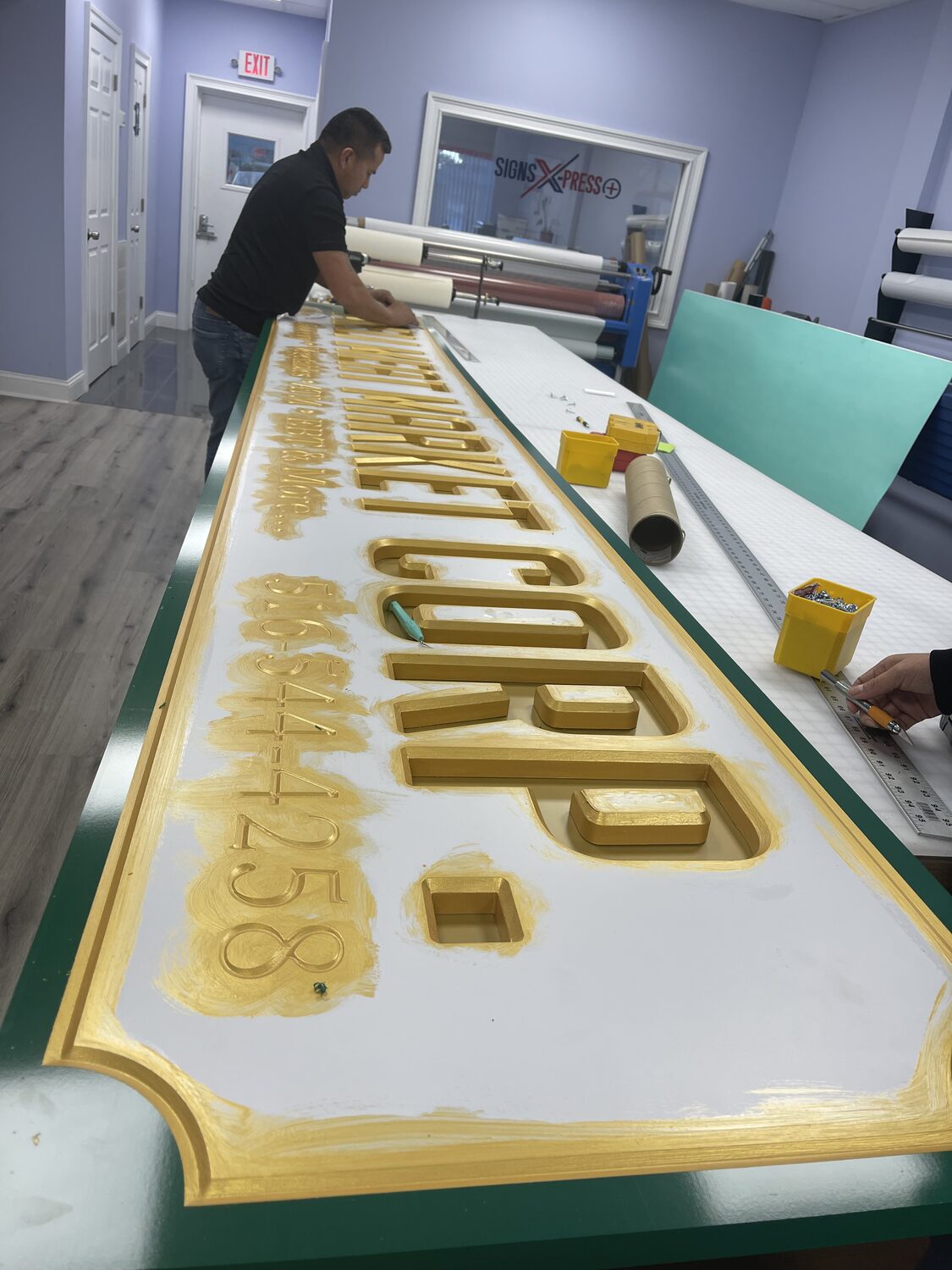 Gold-leaf carved sign on the bench