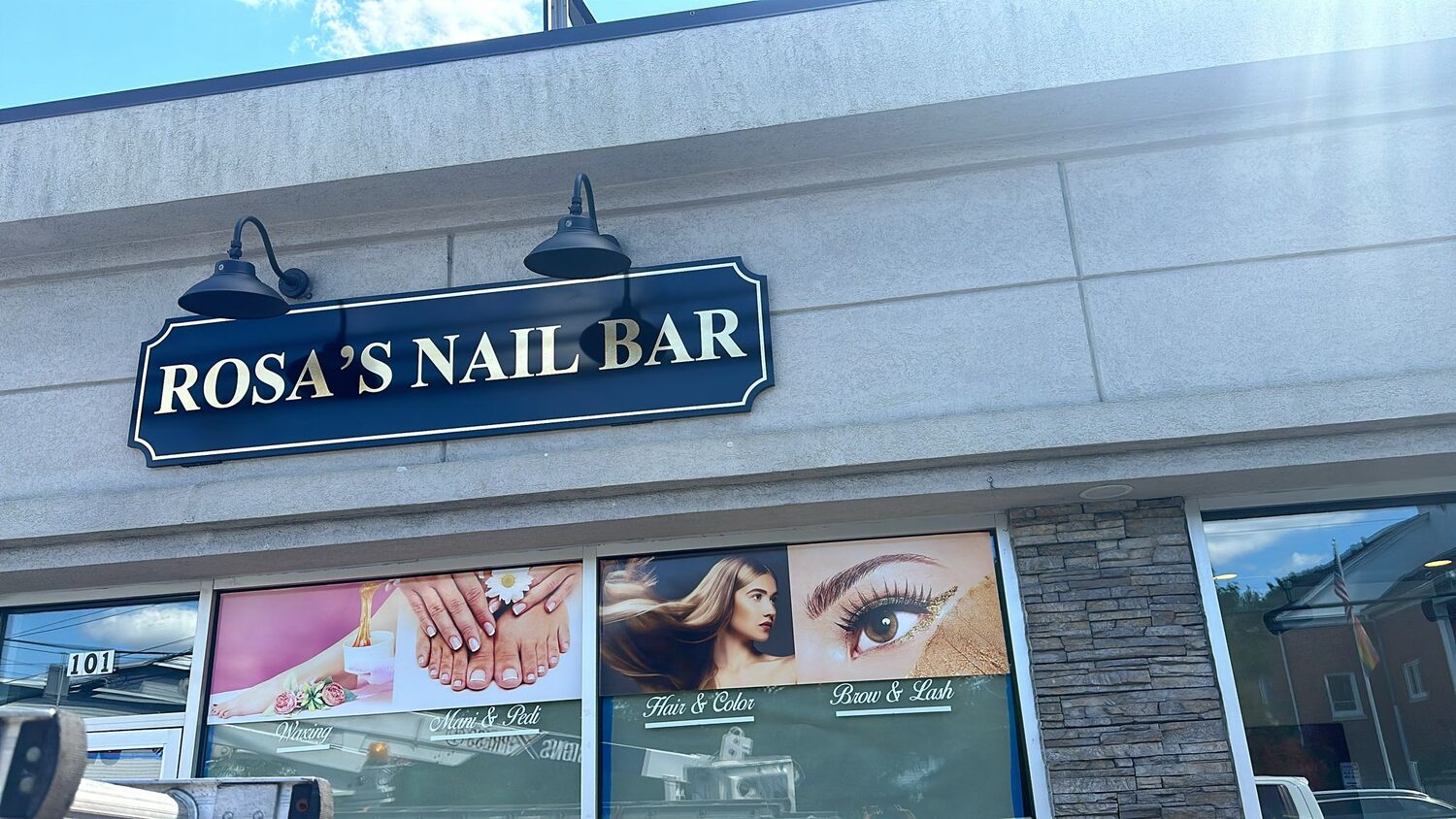 Carved sign with gooseneck lighting for Rosa's Nail Bar